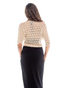 The Knitted Bolero Motiv features an iridescent mother of pearl shell button closure. The body of this bolero is triangle shape with mid length sleeves and a pointed back hem. This crochet piece envelopes whatever you choose to wear underneath it and the detail on it is easily dressed up or down. It lays close to the body and sits at or above the waistline. It's breathable with wonderful airflow and is a perfect item to travel with as it can be worn in many situations. It is made of a super soft Elegant Fitted V-neck Crochet Top, Chic Fitted 3/4 Sleeve Shrug, Elegant Fitted Crochet Top With V-neck, Elegant Open Knit Party Tops, Elegant 3/4 Sleeve Cardigan For Party, Elegant Crochet Top With Open Knit V-neck, Elegant Fitted Cardigan With Short Sleeves, Elegant V-neck Open Knit Crochet Top, Elegant Fitted Open Knit Cardigan