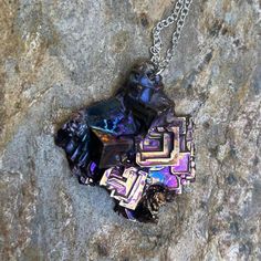 This pure bismuth crystal was created & shaped  myself on a silver plated copper chain and lobster claw closure. The chain length is 20 inches and the whole piece is 21 grams including the 1.7 gram chain. Bismuth naturally forms crystals when melted and cooled slowly. The rainbow coloring comes from natural oxidation the moment the crystal meets oxygen. Since the metal has such a low melting point (~520 F) it's fairly easy to create crystals right at home (with proper safety equipment). Bismuth Crystal Circle, Bismuth Crystal, 20 Inch Necklace, 21 Grams, Melting Point, Pink Drinks, Cluster Necklace, Safety Equipment, Copper Chain