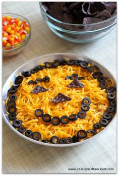 a bowl filled with noodles and candy in the shape of a face on top of it