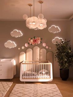 a baby's room with a white crib and flowers on the wall