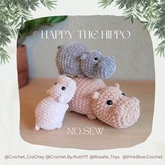 three small crocheted animals sitting on top of a wooden table