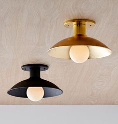 two black and gold lights hanging from the ceiling