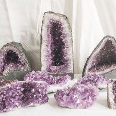 some kind of purple and white object on a white table cloth with other items in the background