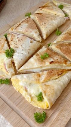 four quesadillas cut in half on a cutting board