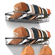 two metal shelves with hats and shirts hanging on them