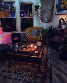 a living room filled with furniture and a christmas tree in front of a window on top of a rug