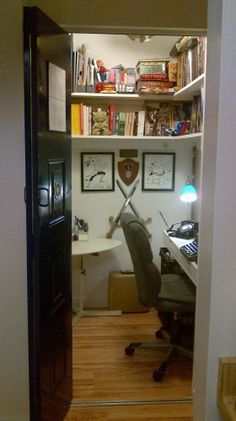 an open door leading to a room with a computer desk and bookshelf in it