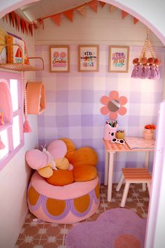 a doll house with pink and orange furniture