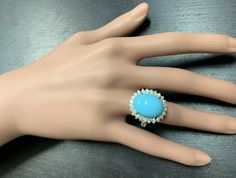 12.30 Carats Impressive Natural Turquoise and Diamond 14K White Gold Ring Suggested Replacement Value $6,500.00 Total Natural Oval Turquoise Weight is: Approx. 11.00 Carats Turquoise Measures: 17.00 x 13.00mm Natural Round Diamonds Weight: Approx. 1.30 Carats (color G-H / Clarity SI1-SI2) Ring total weight: 9.8 grams Disclaimer: all weights, measurements and colors are approximate and may vary slightly from the listed dimensions or as seen in the image. All pictures are magnified to show the sma Luxury Turquoise Diamond Ring As Gift, Formal Turquoise Multi-stone Rings, Formal Fine Jewelry Turquoise Ring With Accent Stones, Formal Fine Jewelry Turquoise Diamond Ring, Formal Oval Turquoise Ring With Diamond, Oval Diamond Turquoise Ring For Formal Occasions, Formal Turquoise Diamond Ring With Gemstone, Formal Turquoise Ring With Accent Stones, Elegant Turquoise Gemstone Ring For Formal Occasions