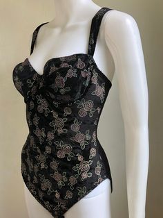 "Velour front bodysuit with metallic floral pattern. Pulls on and has elastic stretch across entire knit nylon back. Elastic stretch to adjustable shoulder straps. Clasp crotch with 2 sets of clasps. Bust has underwire support. condition: excellent color(s): black with metallic fabric(s): fine knit, 95% acrylic, & 5% spandex brand: front - 100% polyester | back - 86% nylon, 14% lycra spandex care: machine wash estimated size: XS (marked Small on tag, please check measurements) ✩ size is esti Fitted Floral Print One-piece Bodysuit, Floral Print Fitted Bodysuit, Fitted Floral Print Bodysuit, Fitted Underwire Leotard, Sleeveless Floral Print Bodysuit For Party, Fitted Underwire Bodysuit For Party, Rayon Shirt, Abstract Floral Print, Metallic Fabric