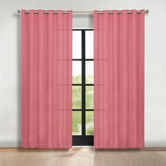 a window with pink curtains in front of it