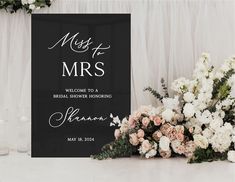 a sign that says mr and mrs next to some flowers