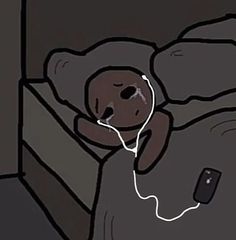 a person laying in bed with an electronic device hooked up to their headphones and plugged into the wall