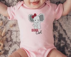 Important holiday update: Christmas delivery on orders placed after Dec. 8th are not guaranteed to arrive before Christmas. If placing an order after this date, refunds will not be offered due to arrival post Christmas holiday. Adorable Bama girl elephant design. A must have for Alabama alumni and fans.   6M 12M 18M 24M Width, in 8.66 10.00 11.02 12.01 Length, in 12.48 13.50 14.49 15.51 Sleeve length, in 2.76 2.99 3.23 3.50 Baby clothing needs to be both durable and soft. With the infant fine jersey bodysuit, youths get just that. The fabric is 100% cotton for solid colors. For heather colors, polyester is included. There are seams along the sides of this product. All bindings are made with ribbed knitting for improved durability. There are plastic snaps at the cross closure for easy chang Pink Short Sleeve Onesie For Gender Reveal, Pink Cotton Onesie With Name Print, Pink Cotton Onesie With Custom Print, Pink Cotton Bodysuit With Name Print, Alabama Baby, Alabama Gifts, Bama Girl, At The Cross, Elephant Design