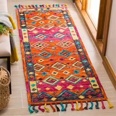 a colorful rug with tassels on the floor