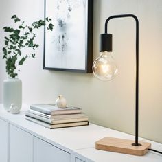 a table lamp sitting on top of a white shelf