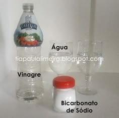 a bottle of water and two glasses on a white surface with the words aqua, vinegar, bicarbonato de sodio