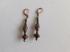 Iridescent beads compliment the bronze colored beads in these earrings. Brass lever back ear wires. The details on the bronze colored beads is a little hard to see in the pictures, but they are great looking earrings. Comfortable and easy to wear. Bronze Round Bead Copper Earrings, Bronze Beaded Dangle Earrings, Bronze Copper Earrings With Round Beads, Bronze Copper Earrings With Dangling Beads, Beaded Bronze Metal Earrings, Bronze Beaded Metal Earrings, Bronze Earrings With Lever Back Ear Wires, Bronze Beaded Drop Earrings, Brown Copper Beaded Earrings With Dangling Beads