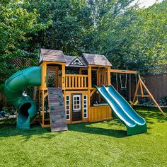 a wooden play set with a slide and climbing frame in the back yard, surrounded by grass