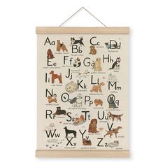 a cross stitch pattern with dogs and letters hanging on a wooden frame, in the shape of a wall hanging