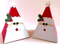 two paper christmas hats on top of each other, one with santa's face