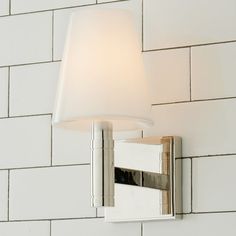 a bathroom light with a white shade on it