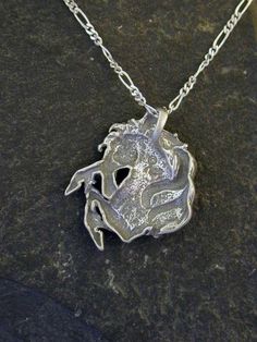 "This Horse pendant is Sterling Silver. The included chain is a Sterling Silver Figaro 50 chain. You may choose 16, 18 or 20 inch at the same price. Other length available at sightly higher prices. This Horse pendant measures 1 1/4\" tall by 1\" across. I hand cast all my pieces using the lost wax casting method. Please ask your needs. You may call me with questions, often I am out so please use my machine. 831-476-3176. Satisfaction Guaranteed! I send items USPS First Class unless otherwise dir Silver Round Pendant Chain Necklace For Anniversary, Custom Silver Pendant Necklace Nickel Free, Silver Custom Necklace With Large Pendant, Unique Silver Round Pendant Charm Necklaces, Unique Silver Round Pendant Charm Necklace, Unique Silver Charm Necklace With Round Pendant, Silver Necklace With Oval Pendant And Box Chain, Custom Silver Pendant Necklace With Large Pendant, Custom Silver Necklace With Large Round Pendant