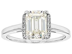 2.10ct emerald cut lab created  Strontium Titanate and .07ctw round white zircon, rhodium over sterling silver ring. Measures approximately 5/16" L x 1/16" W and is not sizeable. Accent stones primarily zircon. Classic Emerald Ring With Brilliant Cut Cubic Zirconia, Classic White Emerald Ring With Halo Setting, Classic Emerald Ring With Diamond Cut Cubic Zirconia, Classic Emerald Ring With Center Stone In Cubic Zirconia, Cubic Zirconia Halo Ring With Emerald Cut, Emerald Cut Sterling Silver Halo Ring With Center Stone, Sterling Silver Baguette Cut Diamond Ring With Center Stone, Classic White Emerald-cut Halo Ring, Baguette Cut Sterling Silver Diamond Ring With Center Stone