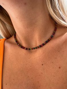 Experience the mystical energy of the cosmos with the Mixed Tourmaline Rondelle Beaded Crystal Choker. This boho-chic necklace features a mix of round Tourmaline beads in shades of pink, green, blue, and clear, accented by a sterling silver chain with lobster clasp. 3mm round Tourmaline rondelle beads Pink, green, blue, and clear Tourmaline 16-18 inches adjustable length Sterling silver chain and clasp. Harness the healing powers of Tourmaline with this crystal healing necklace. Tourmaline energ Festival Natural Stone Beaded Choker Necklace, Bohemian Beaded Choker Necklace With Spacer Beads, Bohemian Style Beaded Choker With Spacer Beads, Bohemian Crystal Choker For Festivals, Adjustable Bohemian Choker With Spacer Beads, Bohemian Beaded Choker, Festival Gemstone Beads Choker Necklace, Festival Crystal Necklace With Beaded Chain, Bohemian Beach Choker With Spacer Beads