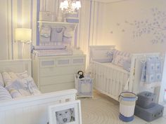 a baby's room is decorated in white and blue