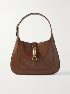 a brown handbag with gold hardwares on the handles