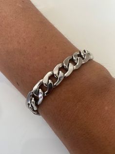 Welcome to my shop. Bold Silver Bracelet for everyone. Suitable from ages 10 to 100 years old. Clasp: Lobster Material: Stainless Steel. Chain: 13 x 10mm The Model in the photo is wearing a chain length of 8inches. This is a Custom order. If you have concerns about your skin colour and the gold colour, please agree with yourself first before buying. We don't know you nor are we magicians to know what shade of gold you like. Please message me for any enquiries.  Thank you 10mm Silver Curb Chain Bracelet, Chunky Chain Bracelet, Men Chain Link Bracelet, Stainless Steel Unisex Bracelet, Christmas Gift Gift Cuban Link Chunky Chain Bracelet, Silver Chain Cuban Link Bracelet As A Gift, Cuban Link Metal Bracelet As Gift, Cuban Link Metal Bracelet For Gift, Everyday Vintage Link Bracelets, Metal Cuban Link Bracelets As Gift, Silver Cuban Link Bracelet With Lobster Clasp As Gift, Silver Chunky Chain Bracelet As Gift, Silver Chunky Chain Bracelet For Gift