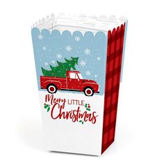 a red truck carrying a christmas tree on it's back in a paper bag