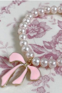 The most precious summer accessory ~ cute as can be and the perfect pop of pearl! Name a better accessory to your LoveShackFancy pieces. Handmade One size fits most ~ elastic band Pearl bracelet with charm detail Cute Adjustable Pearl Bracelet, Adjustable Cute Pearl Bracelet, Adjustable Pink Pearl Bracelet With Charm, Pink Adjustable Pearl Stretch Bracelet, Adjustable Pink Pearl Stretch Bracelet, Trendy Pearl Bracelet With Charm As Gift, Trendy Pearl Bracelet With Pearl Charm As Gift, Pink Pearl Bracelet For Party, Pink Pearl Party Bracelet