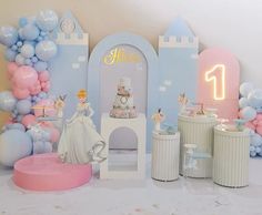 there is a cake and balloons in front of the backdrop for this princess themed birthday party