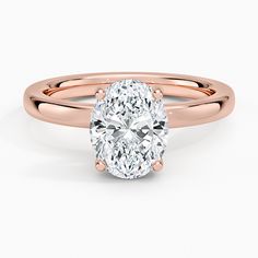 a rose gold ring with an oval cut diamond