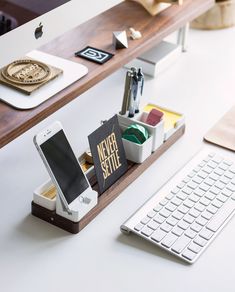 a desk with a keyboard, phone and other items on it