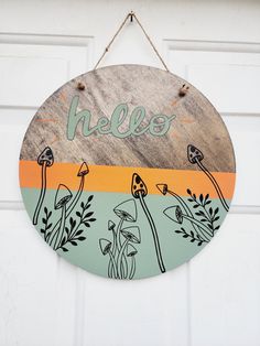 a wooden sign hanging from the side of a door that says,'hello '