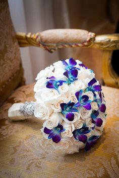 a bridal bouquet sitting on top of a chair