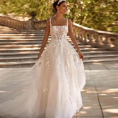 a woman in a wedding dress walking down the street