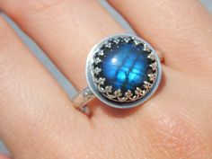 The Doria Ring features a stunning labradorite that glows blue like Dory from Finding Nemo! The intricate sterling silver setting paired with this unique stone make it a future heirloom! I hope you enjoy this piece for many years to come! Details: Size 10 (can be sized up to 11. Just let me know with a note at checkout! Intricate sterling silver setting with gorgeous floral band High quality round labradorite This item will be shipped within 5 business days. Each piece is handmade by me in my st Dory From Finding Nemo, Silver Labradorite Moon-shaped Jewelry, Dory Finding Nemo, Finding Nemo, Size 10 Rings, Druzy Ring, Turquoise Ring, Labradorite, Gemstone Rings