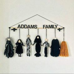 a group of scarves hanging from a wooden sign that says adams's family