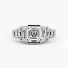 an emerald cut diamond ring with three baguetts