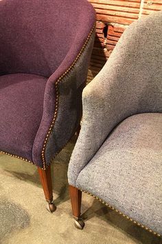 two upholstered chairs sitting next to each other