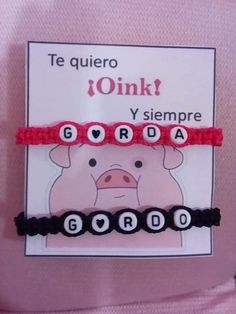 two bracelets that say i love you in spanish and the words pig on them