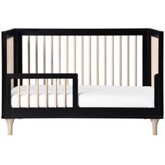 a baby crib with white sheets and black wood slats on the bottom half