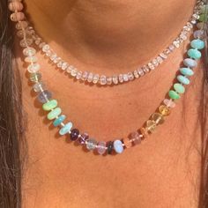 Our Rainbow 'Love' Necklace features an array of gemstones including, but not limited to, Peru and Pink opal, Rose Quartz, Moonstone, Chrysoprase, Strawberry Quartz, Peach Moonstone, Fluorite, Prehnite, Amethyst, Larimar, Sky blue Apatite and Ruby. DETAILS Metal : 14ct Gold Vermeil Gemstone : mixed Length : Various Bead size : 7-8mm Thread : grey silk knotted ABOUT THE GEMSTONES Incorporates all the colours of the chakra, to promote balance and self love. We seek out stones for their unique beau Round Beads Crystal Necklaces With Stones, Round Bead Mineral Crystal Necklaces, Mineral Crystal Necklaces With Round Beads, Round Beads Mineral Crystal Necklace, Gift Rondelle Necklace With Gemstone Accents, Gemstone Accents Rondelle Necklace Gift, Round Mineral Crystal Gemstone Necklace, Fusion Style Opal Gemstone Jewelry, Rondelle Crystal Necklaces With Natural Stones For Gifts