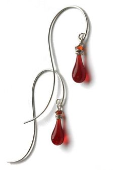 The elegant, trailing curve of these earrings is balanced by a dainty teardrop of sun-melted glass. Front earring length: 1 1/4" - 1 1/2" (varies depending on teardrop length); Back earring length: 2" Eco-friendly jewelry, made from recycled sterling silver and sun-melted recycled bottles and stained glass 20-gauge recycled sterling silver earrings are nickel free and hypoallergenic Lightweight and comfortable to wear Handmade in the USA Materials: Sun-melted glass and recycled silver Show off y Vine Earrings, Garden Vines, Hanging Vines, Translucent Glass, Eco Friendly Jewelry, Recycled Bottles, Argentium Silver, Recycled Silver, Glass Art Sculpture