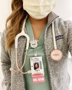 a nurse wearing a face mask and stethoscope with her name tag on it