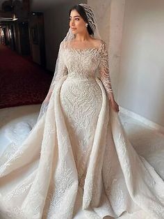 a woman in a wedding dress is posing for the camera